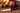 Fotografía mostrando cuchillo fileteador 100 mm serie Ópera junto con futas como dos manzanas, plátanos, fresas...