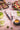 Fotografía de tenedor y cuchillo chuletero serie The Origin tono azul rodeada de platos de comida y bebida